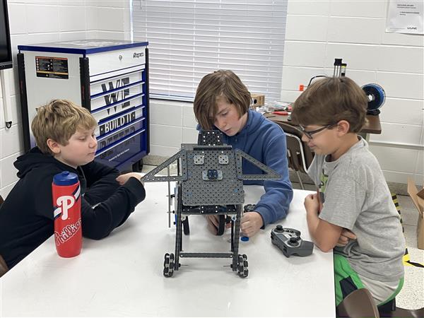 Students with a robotic dog.